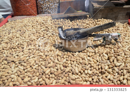 Pile of peanuts on market. A pile freshly cooked steamed peanuts in shell in a big bowl in street for sale on Sonamarg. India. 131333825