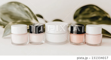 Cosmetic jars with green leaves in background, natural beauty concept Cosmetic jars with green leaves in background, natural beauty concept 131334017
