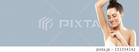 Armpit epilation, lacer hair removal. Young woman holding her arms up, depilation  smooth clear skin. Panorama; 131334142