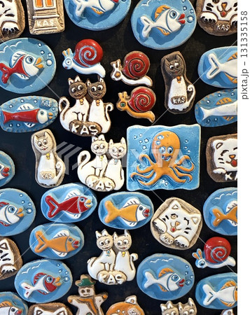 Colorful animal themed magnets displayed on a black surface background 131335158