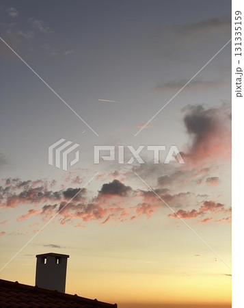 Beautiful sunset with dramatic clouds and chimney silhouette, perfect for background use Beautiful sunset with dramatic clouds and chimney silhouette, perfect for background use 131335159