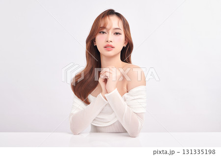 A beautiful young Asian woman with clean, fresh skin against a white background. Skincare, facial treatment, cosmetology, beauty, and spa. An elegant portrait of an Asian woman. A beautiful young Asian woman with clean, fresh skin against a white background. Skincare, facial treatment, cosmetology, beauty, and spa. An elegant portrait of an Asian woman. 131335198