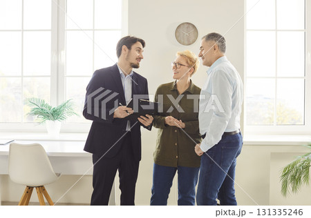 Senior Couple Viewing New Home With Realtor Senior Couple Viewing New Home With Realtor 131335246