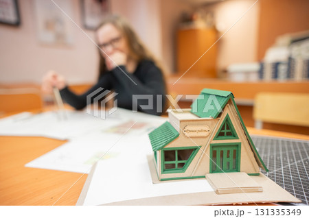 Caucasian young woman making drawings. Student of architecture university.  131335349