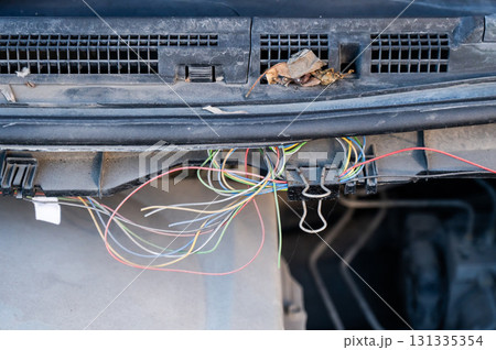 Electrical fault in car. Wires sticking out. Electrical fault in car. Wires sticking out. 131335354