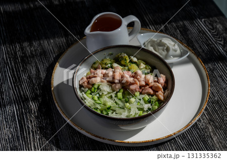 Okroshka with chicken on kvass in a cafe. Okroshka with chicken on kvass in a cafe. 131335362