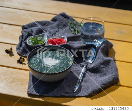 Traditional Russian lunch in a cafe. Top view of okroshka on a table in a summer cafe. Traditional Russian lunch in a cafe. Top view of okroshka on a table in a summer cafe. 131335429
