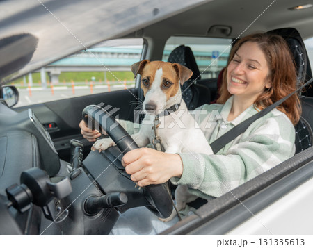Caucasian woman traveling by car with her dog. Caucasian woman traveling by car with her dog. 131335613