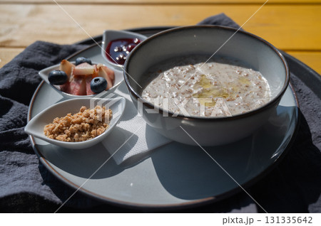 Reserved breakfast at a cafe. A plate of porridge on a table in a street cafe. Reserved breakfast at a cafe. A plate of porridge on a table in a street cafe. 131335642