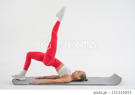 Caucasian woman doing sports exercises on white background.  131335655