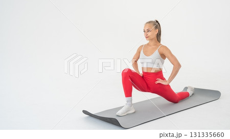 Young woman doing splits exercises on white background. 131335660