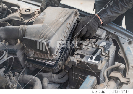 Mechanic changing the air filter.  131335735