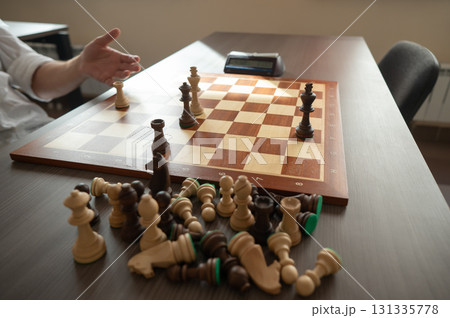 Close up of hands of middle aged caucasian man playing chess.  131335778