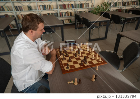Caucasian man upset after losing chess game. Caucasian man upset after losing chess game. 131335794