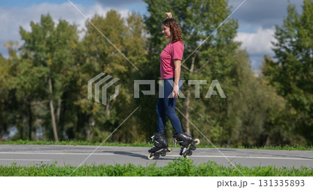 Caucasian woman roller skating in park. Caucasian woman roller skating in park. 131335893