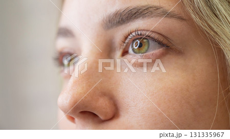 Close-up portrait of a woman after eyelash lamination procedure. Close-up portrait of a woman after eyelash lamination procedure. 131335967