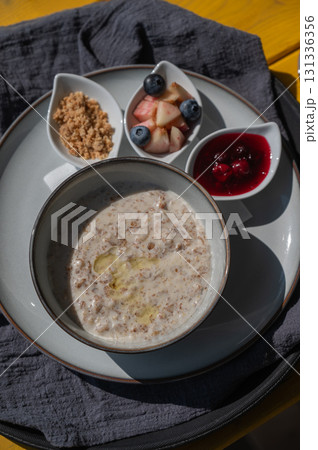 Reserved breakfast at a cafe. A plate of porridge on a table in a street cafe. Reserved breakfast at a cafe. A plate of porridge on a table in a street cafe. 131336356
