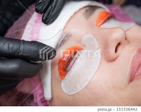 Caucasian woman undergoing eyelash lamination procedure.  131336442