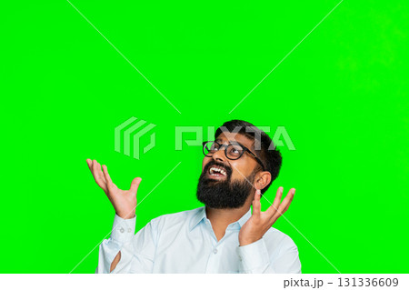 Indian man raising hands looking up reaching above head for promo banner text logo on chroma key Indian man raising hands looking up reaching above head for promo banner text logo on chroma key 131336609