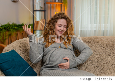 Pregnant young woman talking to belly at home gently touching bonding with baby emotional connection Pregnant young woman talking to belly at home gently touching bonding with baby emotional connection 131336715