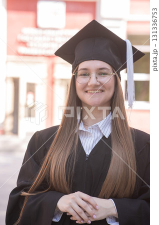 Young happy caucasian woman in graduation gown. Young happy caucasian woman in graduation gown. 131336753