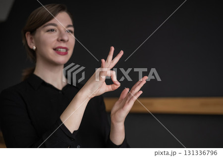 Woman showing the word urgent in Russian sign language.  131336796