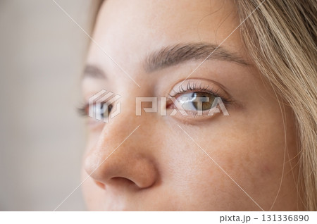 Close-up portrait of a woman after eyelash lamination procedure.  131336890