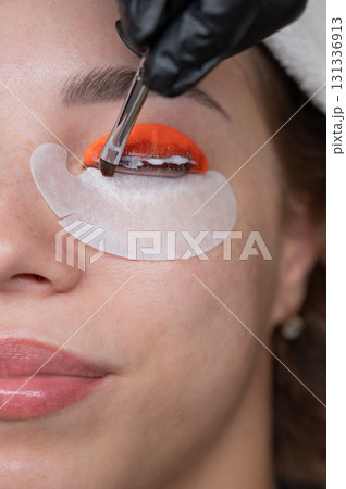 Caucasian woman undergoing eyelash lamination procedure. Caucasian woman undergoing eyelash lamination procedure. 131336913