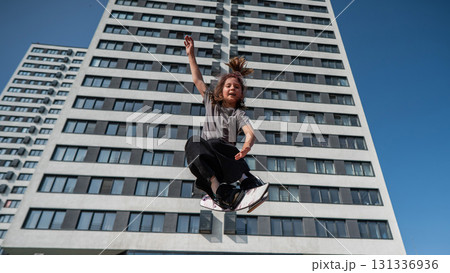 Girl practices skiing tricks on a trampoline. Girl practices skiing tricks on a trampoline. 131336936
