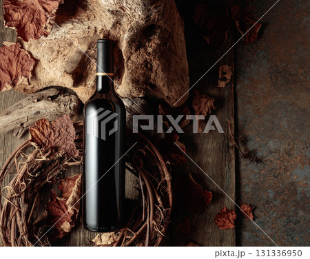 Bottle of red wine on a vintage rustic background. 131336950