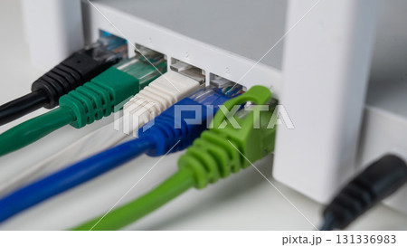 Colorful Ethernet Cables Connected to a Router. Colorful Ethernet Cables Connected to a Router. 131336983