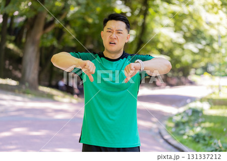 Upset sportsman showing thumbs down dislike gesture expressing discontent disapproval dissatisfied 131337212