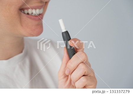Woman smoking tobacco heating system. Electronic cigarette. 131337279