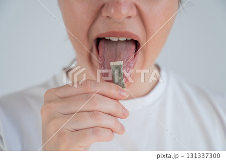 Woman Chewing Nicotine Snus Product.  Woman Chewing Nicotine Snus Product.  131337300