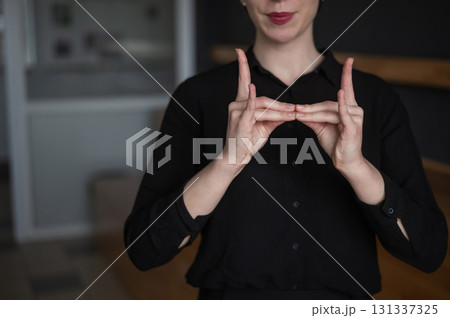 Woman showing the words hostel and bed in sign language. Woman showing the words hostel and bed in sign language. 131337325