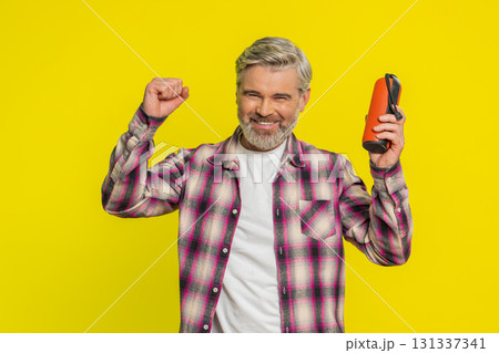Happy man dancing with portable speaker, joyful freedom, musical expression groove, listening music 131337341