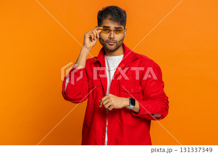 Proud Indian stylish man wearing sunglasses, charming smile, feels happy successful success victory 131337349