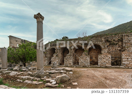 Ancient Roman ruins of Ephesus, with a Corinthian column and arched stone walls, Selcuk, Turkey 131337359