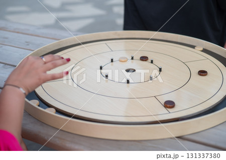 Strategic Game Pieces on a Wooden Board crokinole.  131337380