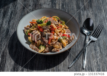 Pasta with beef, mushrooms and vegetables.  131337416