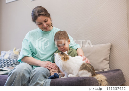 Caucasian woman with her son in a cat cafe.  131337422