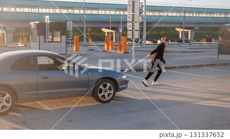 Caucasian man pulling a car with a rope.  131337652