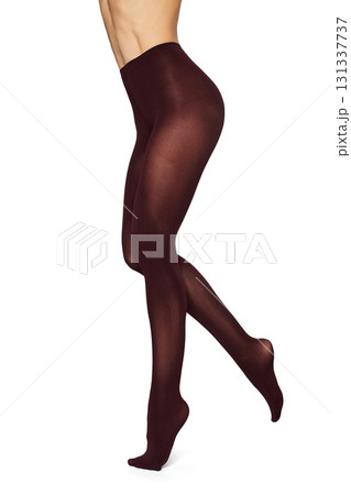 Beautiful long fit female legs in burgundy tights on white background Beautiful long fit female legs in burgundy tights on white background 131337737