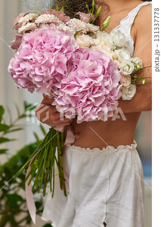 female hands holding bouquet flowers. Gift on the 8 march or valentines day. pink hydrangea 131337778