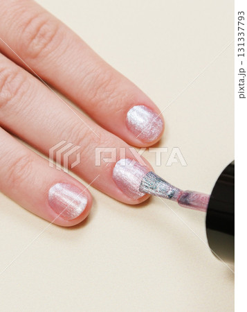 manicure in a beauty salon or at home, a woman paints her nails. manicure in a beauty salon or at home, a woman paints her nails. 131337793