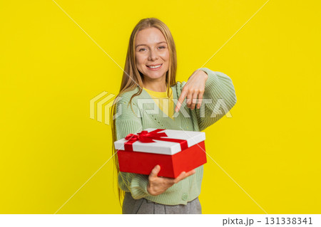 Smiling woman presenting birthday gift present box stretches out hands, promotion discount sale Smiling woman presenting birthday gift present box stretches out hands, promotion discount sale 131338341