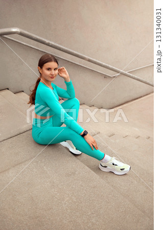 Fitness Girl On Stairs Has Rest. Fit Woman On Break From Exercising.  Female In Fashion Sporty Outfit Doing Interval Cardio Workout Outdoor In City 131340031