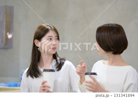 カフェで並んでコーヒーを飲む女性 131341894