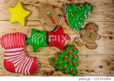 Tasty festive Christmas gingerbread cookies on wooden table. Top view Tasty festive Christmas gingerbread cookies on wooden table. Top view 131341909