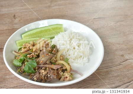 boiled chop pork with liver Thai salad taste spicy and sour on plate eat coupl rice and fresh cucumber 131341934